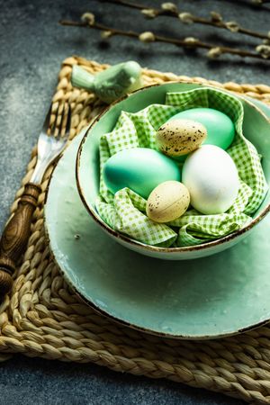 Easter holiday table setting with close up of pastel eggs