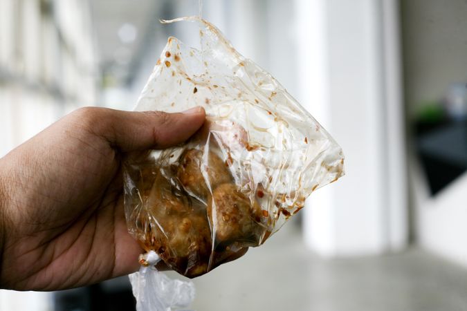 Person holding delicious pentol in bag