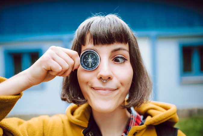 Funny woman with compass near eye
