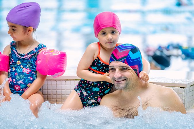 Family relaxing in bubbling pool