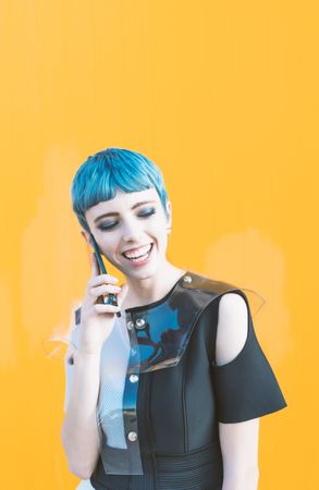 Cheerful futuristic woman talking on smartphone