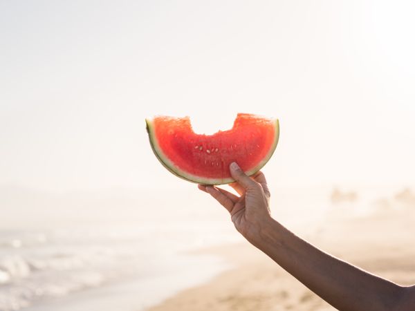 Hand of a person holding red watermelon