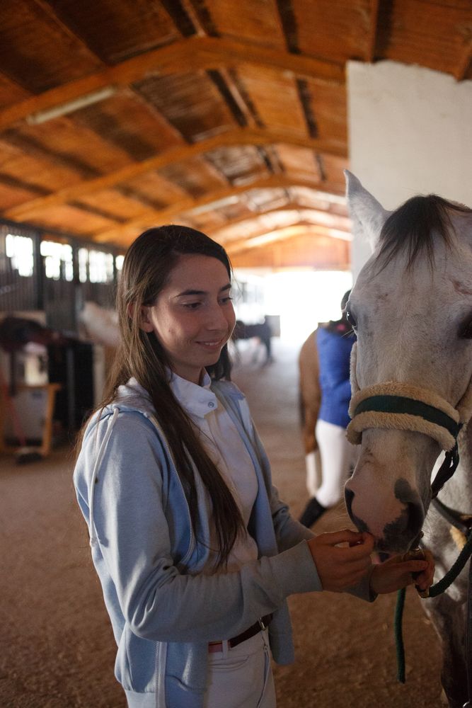 Girl with adorable pony in hat