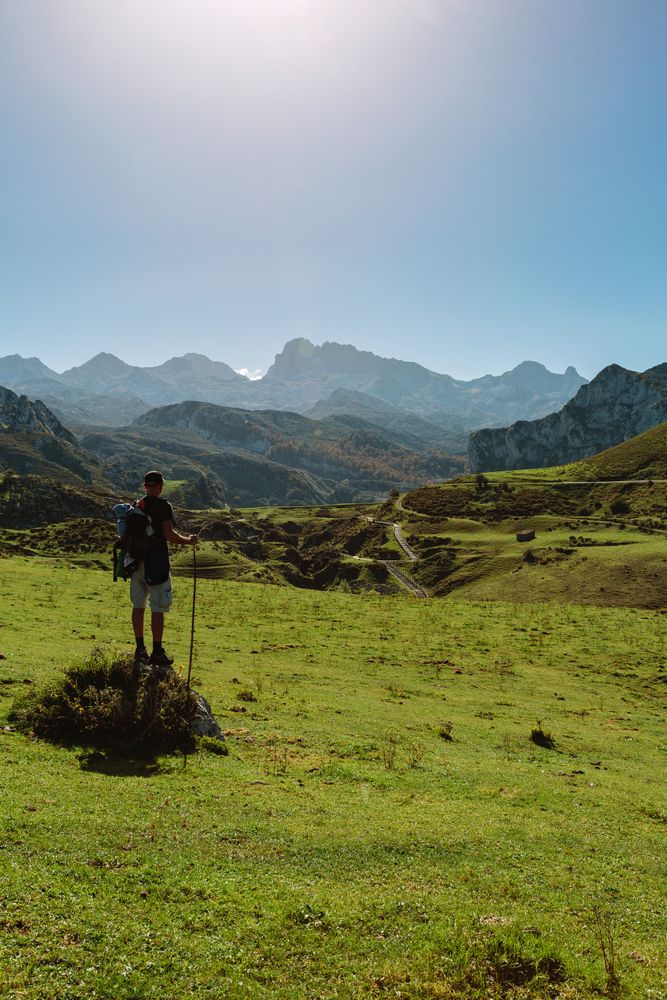 Mountaineer looking landscape with path between mountains