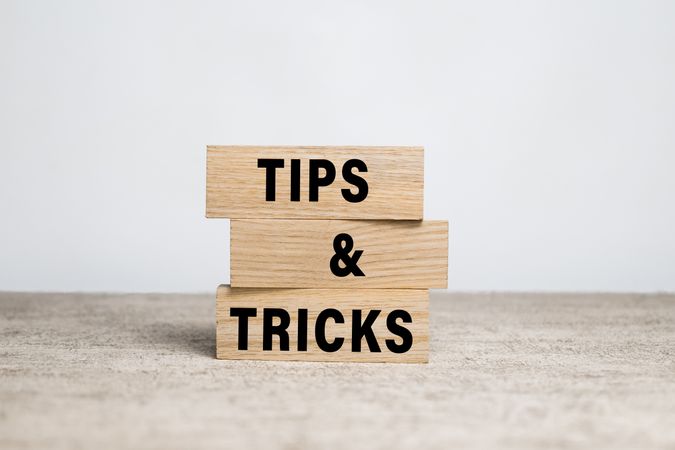 tips and tricks words on wooden blocks on neutral background