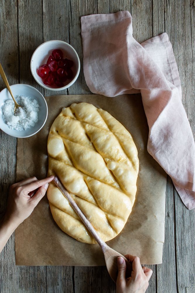 Faceless cook preparing Spanish pie coca San Juan
