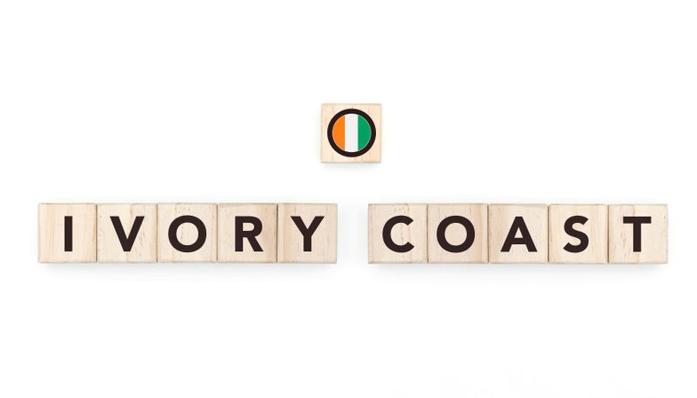 Wooden blocks bearing the name and flag of Ivory Coast. Ivorian and African Culture, national identity, travel, and geography in a copy space design.