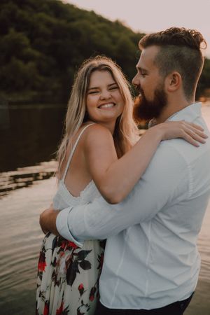 Loving couple standing ankle deep in water on beach