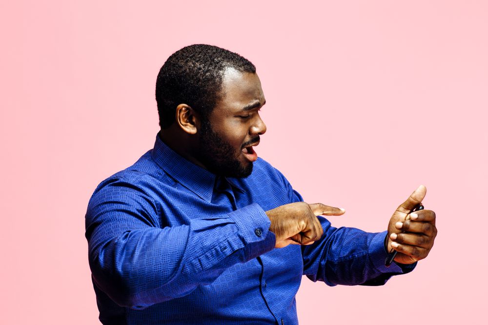 Businessman in blue shirt using cellphone sending a text message, checking received email message, male blogger browsing website in social media