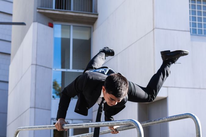 Businessman doing parkour in city district