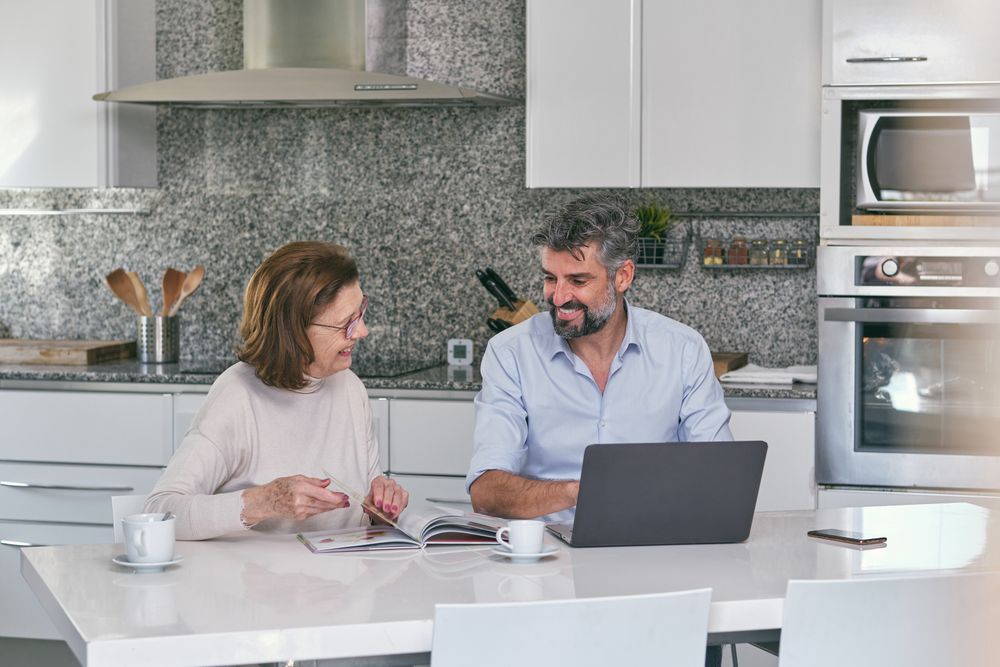 Mother and adult son spending time together in kitchen a