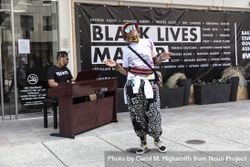 Woman performing with a man accompanying on the piano at a BLM event, Washington, D.C. 5kQkWb