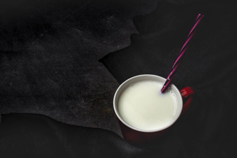 Cup of milk on table