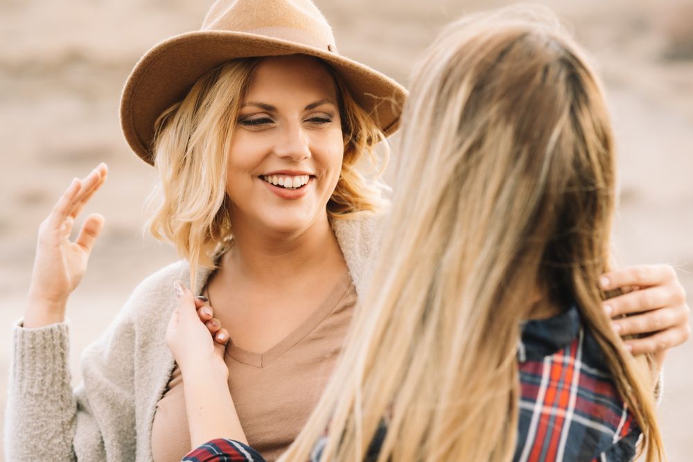 Content blond women cuddling on nature
