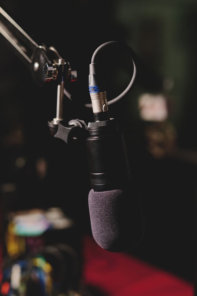 Modern microphone in dark studio