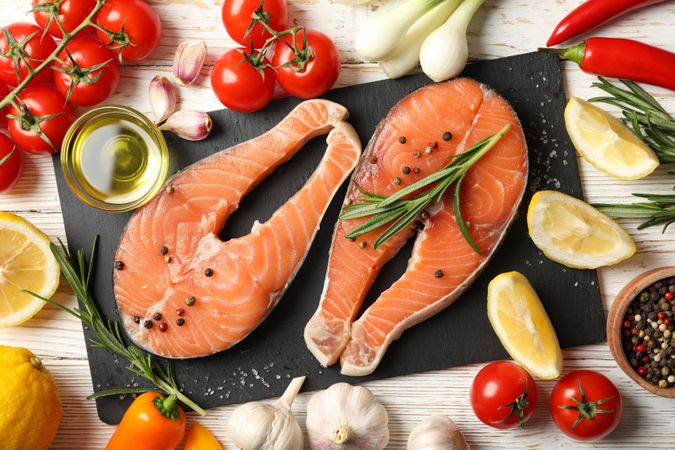Composition with salmon meat and spices on wooden background, top view