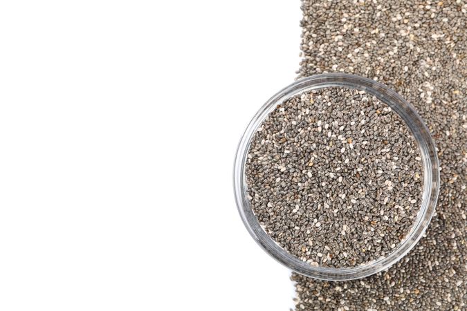 Chia seeds and glass bowl isolated on neutral background