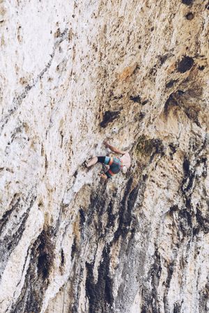 Anonymous man climbing rock