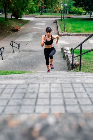 Female athlete climbing stairs outdoors