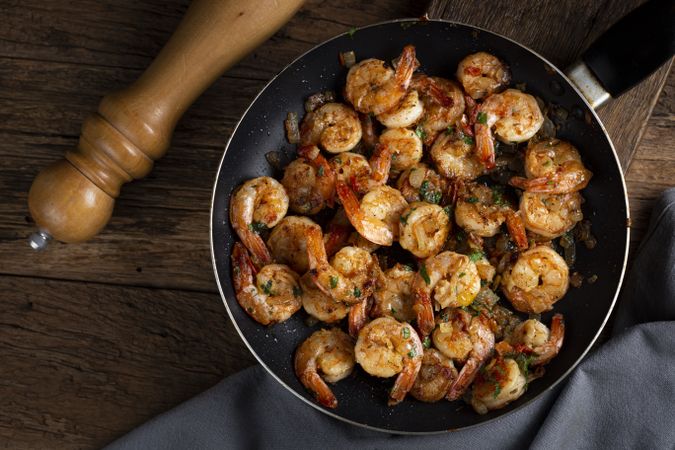 Delicious grilled prawns on wooden background.
