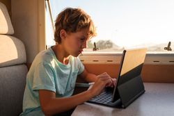 Boy using tablet near trailer window