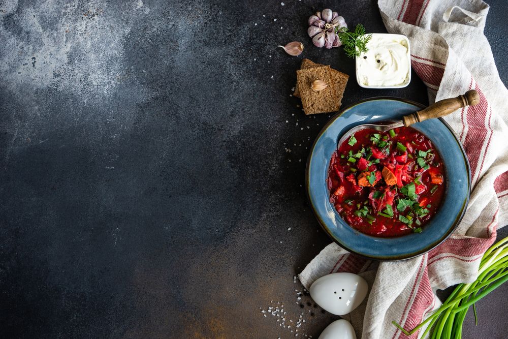 Ukrainian beetroot soup borscht on conter with copy space