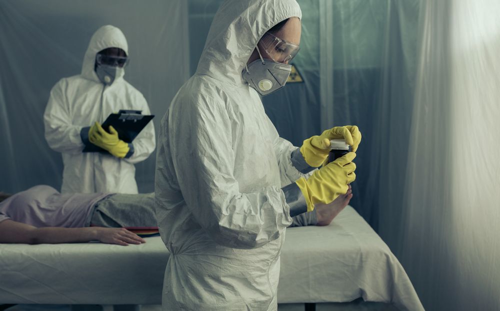 Doctors preparing medication for sick woman