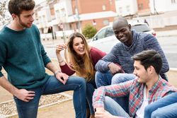 Friends laughing and smiling together in city