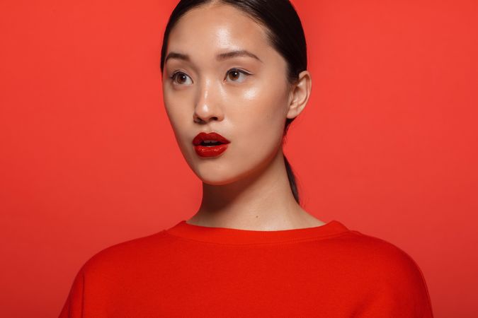 Korean female model with red top and lipstick