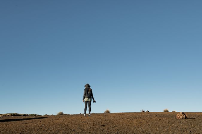 Woman with camera in desert