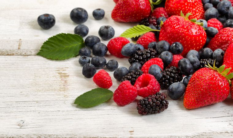 Freshly picked berries on rustic wooden boards