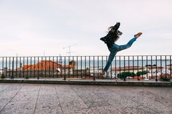 dancer jumping against cityscape