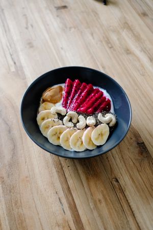 Fresh breakfast bowl with fruit, nuts and yogurt