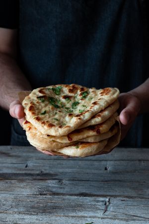 Crop man demonstrating naan bread