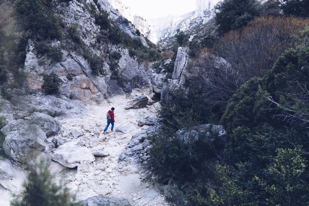 Woman walking between stone hills