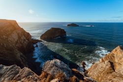 High cliff near water in sunny day