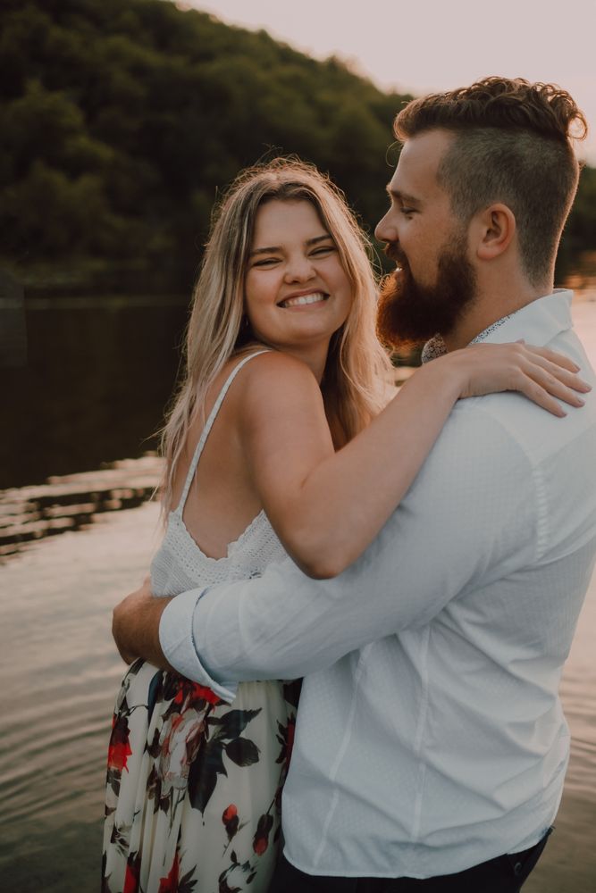 Loving couple standing ankle deep in water on beach