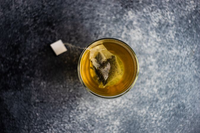 Glass of green tea on grey counter