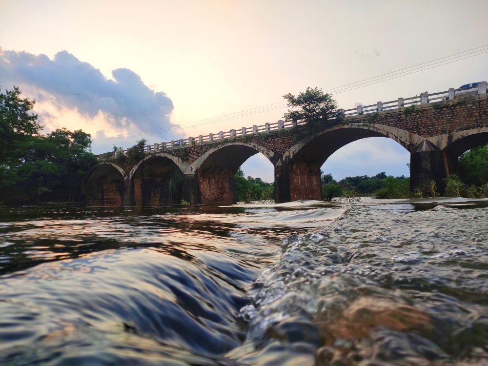 Brown concrete bridge over river in Dadoriya, Rajasthan, India