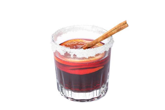 Glass of tasty mulled wine isolated on studio background