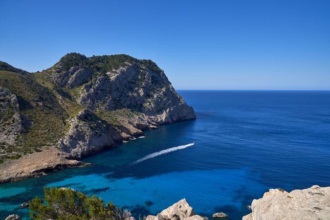 Breathtaking view of turquoise sea washing green cliffs