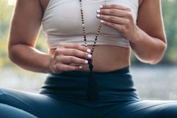 Young woman meditating and doing yoga in nature