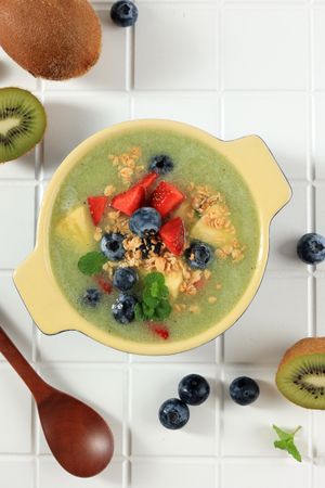 Top View Fresh Kiwi Smoothies Juice with Fruits and Oats Topping