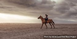 Side view of woman horse rider on beach at sunset bGMNl5