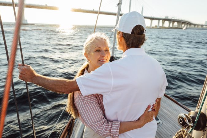 Romantic couple embracing on a boat at sunset