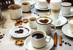 Variety of coffee drinks and fragrant garnishes on table