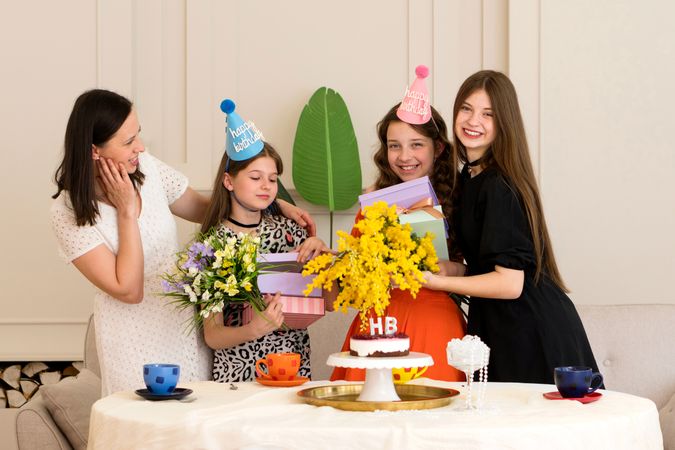 Mother and daughters celebrating birthday at home.