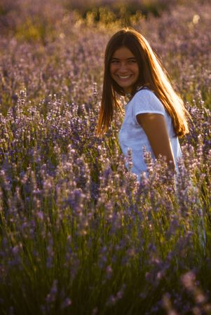 Female in blooming field during sunset
