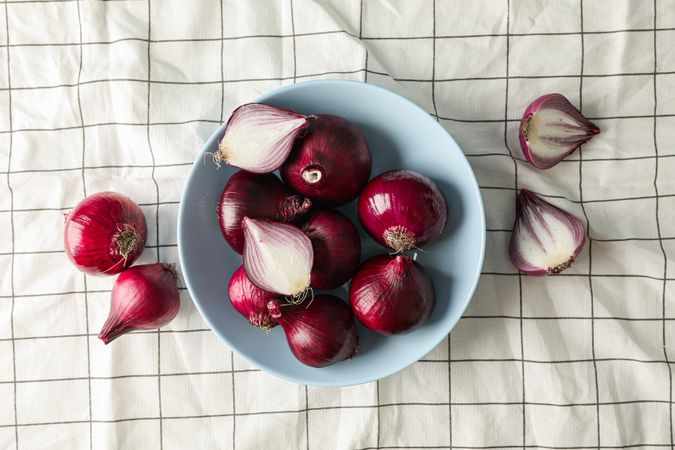 Flat lay composition with red onion on towel background