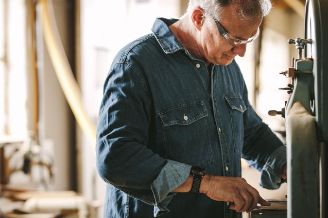 Mature male carpenter working in his workshop